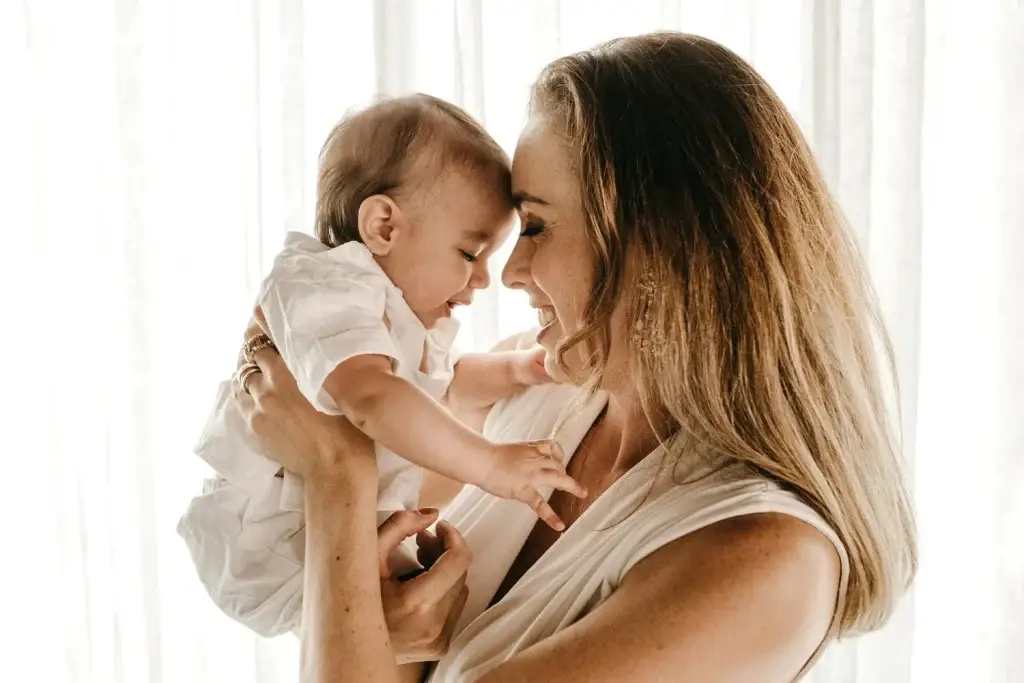 Mother smiling and holding her baby close